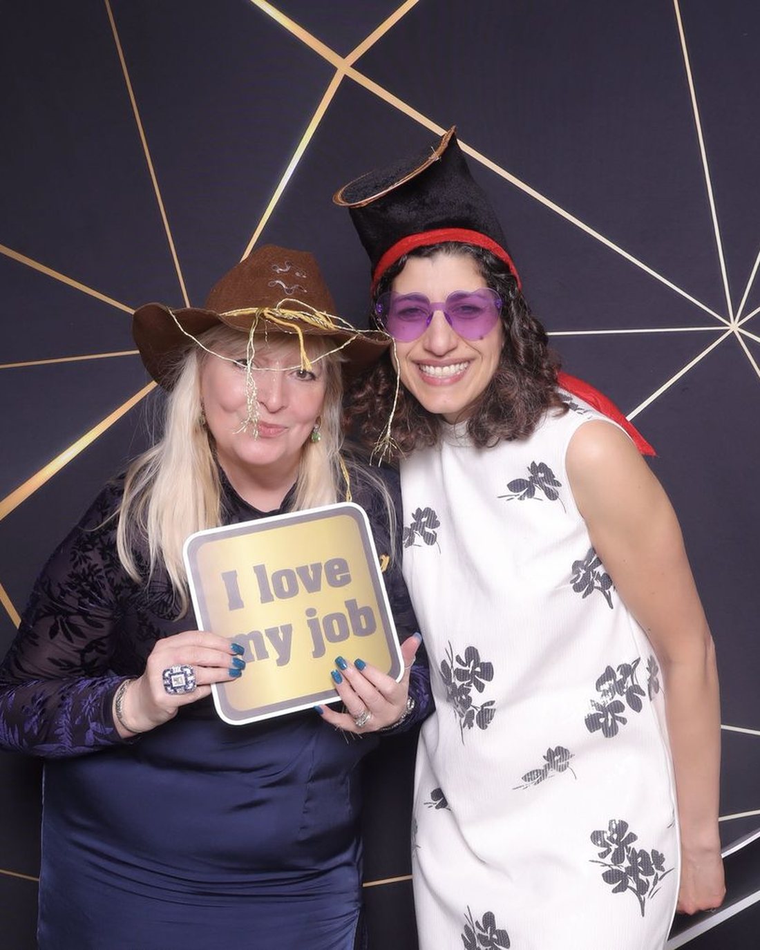 Guests at a corporate awards night with an I love my job sign